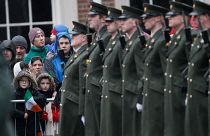Members of the public wait for the President of Ireland Michael D. Higgins to inspect the Irish defense forces guard of honour at Dublin Castle, Ireland, Friday Jan. 1, 2016.