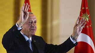 Recep Tayyip Erdogan gestures to supporters at the presidential palace, in Ankara.