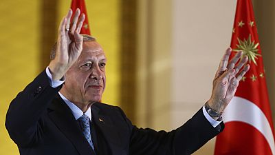 Recep Tayyip Erdogan gestures to supporters at the presidential palace, in Ankara.