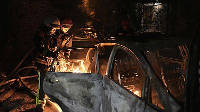 Emergency workers extinguish a fire caused by falling debris from the latest aerial Russian attack in the Pecherskyi district of Kyiv, Ukraine, Tuesday, May 30, 2023
