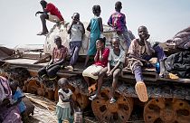 Children sit and play on the remains of a tank, at the river port in Renk, South Sudan Wednesday, May 17, 2023.