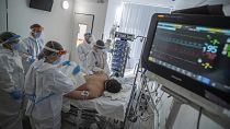 Doctors and nurses wearing protective gears attend a patient on ventilator at the ICU of Szent Laszlo Hospital, in Budapest, treating COVID-19 patients, Dec. 13, 2021.