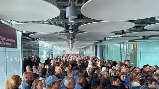 People queue at arrivals at Heathrow airport in London, Saturday, May 27, 2023.