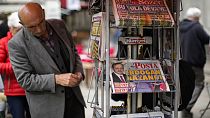 A man reads Turkish newspapers a day after the presidential election day in Istanbul, Turkey, Monday, May 29, 2023.