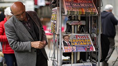 A man reads Turkish newspapers a day after the presidential election day in Istanbul, Turkey, Monday, May 29, 2023. 