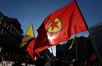 Pro Kurdish activist wave a Kurdistan Workers Party, PKK, flag and shout slogans as they protest against Turkish military operations on 9 October 2019.