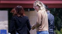 Disgraced Theranos CEO Elizabeth Holmes bieng escorted by prison officials into a federal women’s prison camp. 