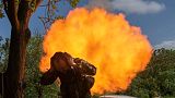 A Ukrainian soldier covers his ears while firing a mortar at Russian positions on the frontline near Bakhmut, Donetsk region, Ukraine, Monday, May 29, 2023. 
