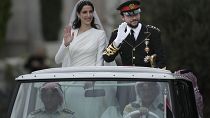 The Crown Prince and Princess of Jordan parade through the streets of Amman after marrying at Zahran palace