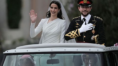 The Crown Prince and Princess of Jordan parade through the streets of Amman after marrying at Zahran palace
