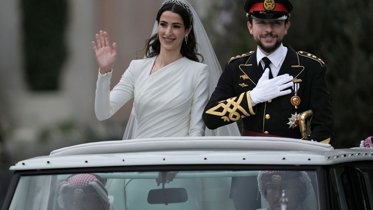 The Crown Prince and Princess of Jordan parade through the streets of Amman after marrying at Zahran palace