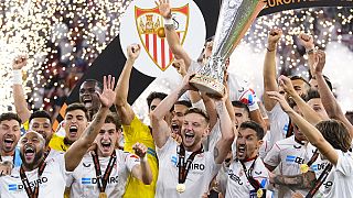Sevilla's team captains Ivan Rakitic and Jesus Navas, lift the Europa League trophy after beating AS Roma on penalties. Budapest, Hungary, May 31, 2023