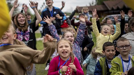 Children dance at the recovery camp for children and their mothers affected by the war near Lviv, Ukraine, Wednesday, May 3, 2023. 