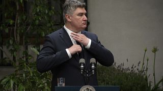 Croatia's President Zoran Milanovic adjusts his tie at a press conference with Chilean President Gabriel in Chile. 12 December 2022