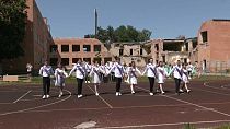 Graduates of two schools, bombed by Russian aircraft in March 2022 danced their last waltz in the yard of their ruined school buildings on Wednesday.