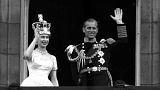 Britain's Queen Elizabeth II and Prince Philip, Duke of Edinburgh wave to supporters from the balcony at Buckingham Palace, following her coronation at Westminster Abbey