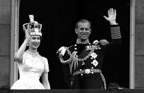 Britain's Queen Elizabeth II and Prince Philip, Duke of Edinburgh wave to supporters from the balcony at Buckingham Palace, following her coronation at Westminster Abbey