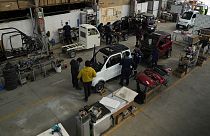 Employees work on a Quantum electric car assembly line at a factory in Cochabamba, Bolivia.