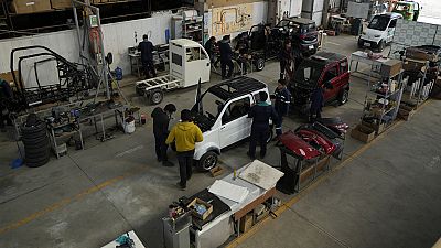 Employees work on a Quantum electric car assembly line at a factory in Cochabamba, Bolivia.