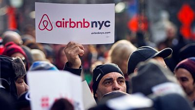 Supporters of Airbnb hold a rally outside City Hall in New York.