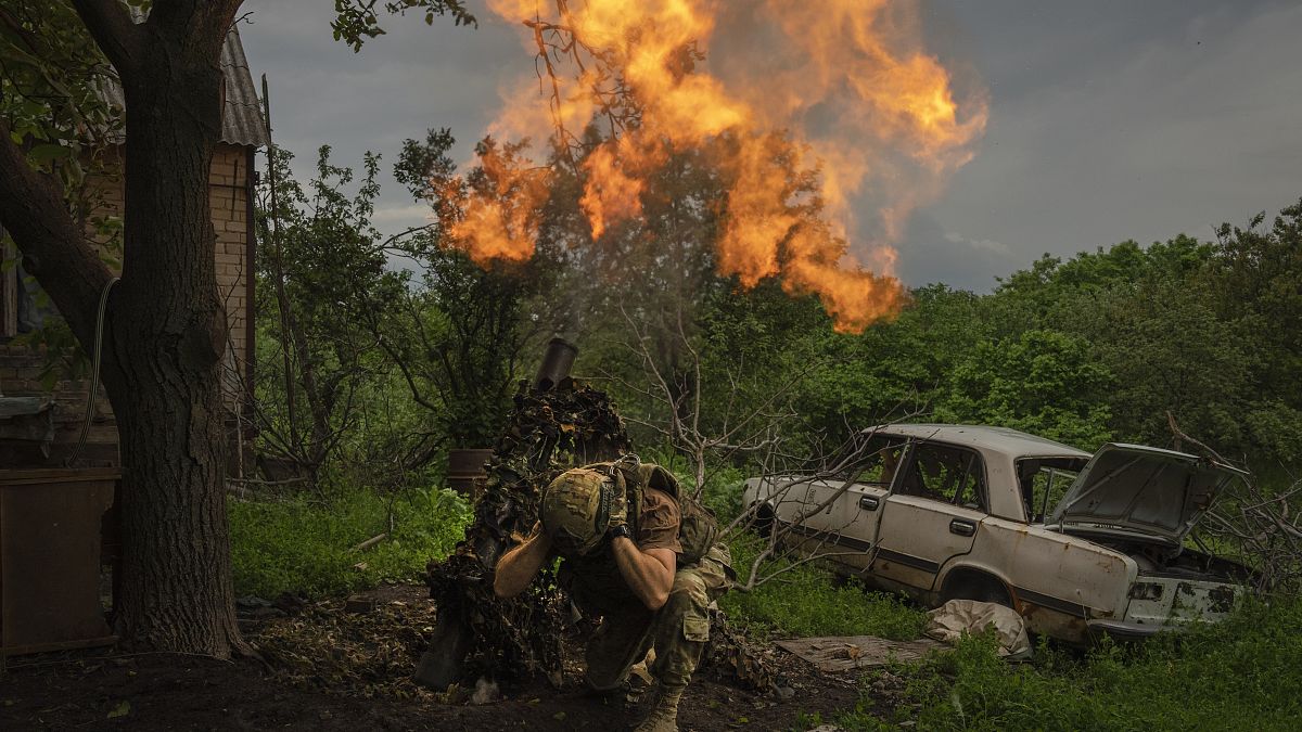 Ukrainian soldier fires a mortar at Russian positions on the frontline near Bakhmut