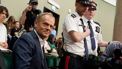 Poland's opposition leader and former PM Donald Tusk watches lawmakers approve a contentious law in parliament in Warsaw. 26 May 2023