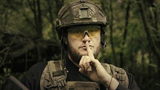 In this image made from video provided by Ukrainian Defense Ministry on Sunday, June 4, 2023, a Ukrainian soldier poses for the camera with his fingers to his lips