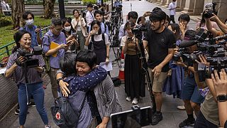 Award-winning Hong Kong journalist Bao Choy, front right, hugs Sham Yee-lan, former Hong Kong Journalists Association chairperson, after being cleared by the city's top court