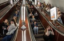 People take cover at a metro station during a Russian rocket attack in Kyiv.