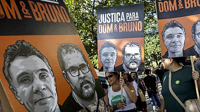  Protesters hold banners of British journalist Dom Phillips (left) and indigenous expert Bruno Pereira one year after they died. Rio de Janeiro, Brazil, June 5, 2023