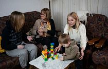 FILE - Ukrainian refugees sit in a home of a resident in the village of Guissona, Lleida, Spain, Thursday, March 17, 2022. 
