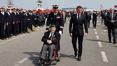 French President Emmanuel Macron (front R) and French WWII veteran of the Commando Kieffer Leon Gautier (C).