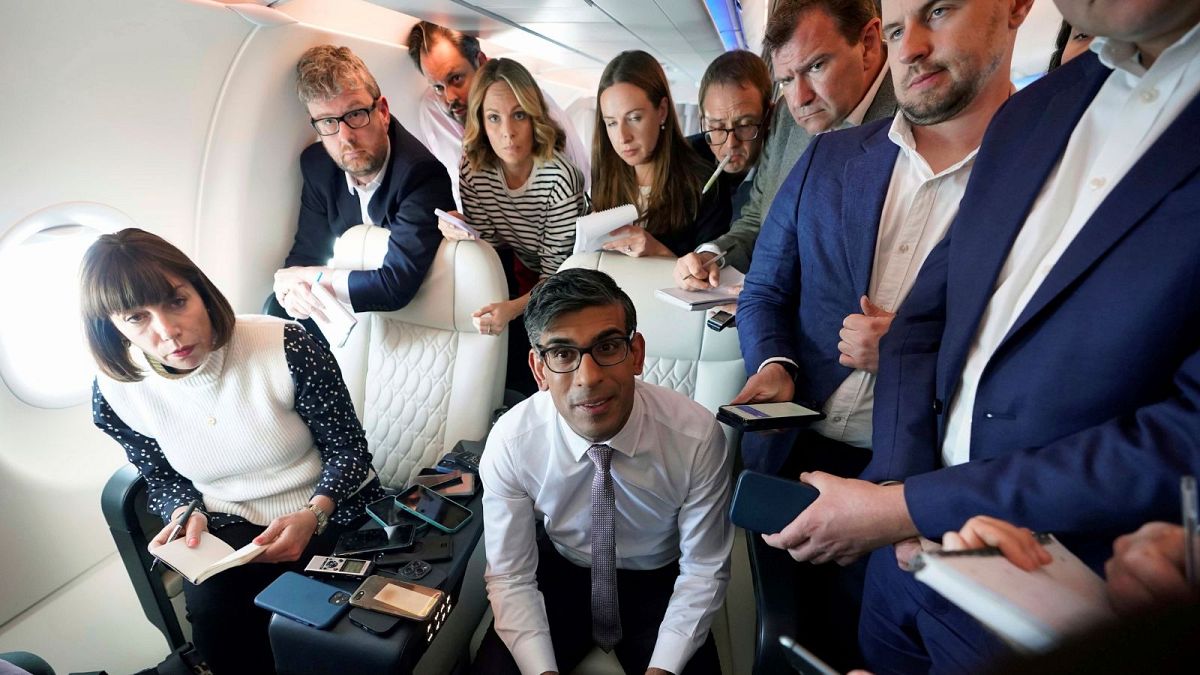 Britain's Prime Minister Rishi Sunak holds a meeting with political journalists on board a government plane as he heads to Washington DC