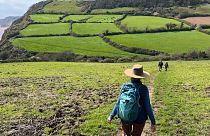 Susan Cunningham hikes near Salcombe Regis, part of the 630-mile South West Coast Path in southern England on April 25, 2023. 