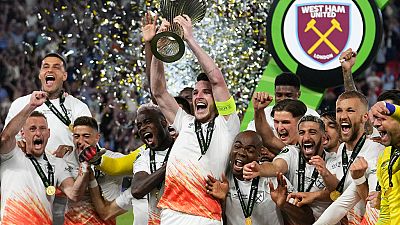West Ham's Declan Rice lifts the trophy after winning the Europa Conference League final soccer match between Fiorentina and West Ham at the Eden Arena in Prague, Wednesday.