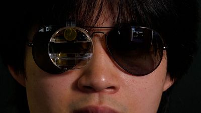 Image shows Bryan Chiang wearing his ChatGPT eyewear prototype that combines augmented reality glasses with software called RizzGPT