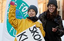 Greta Thunberg holds a sign reading, "School strike for the climate" as she attends a climate march, in Turin, Italy, Friday 13 December 2019.