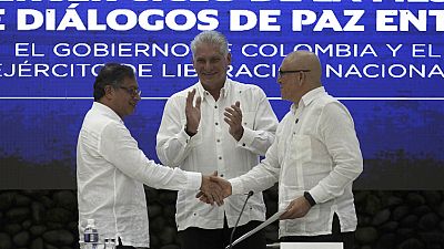 Cuban President Miguel Diaz-Canel shakes hands with ELN commander Antonio Garcia during a bilateral ceasefire agreement in Havana, Cuba, Friday, June 9, 2023