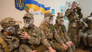 Cadets practice with gas masks during a lesson in a bomb shelter in a cadet lyceum in Kyiv