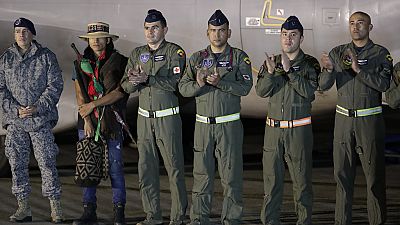 Air Force officers applaud during the arrival of four Indigenous brothers who were missing after a deadly plane crash at the military air base in Bogota, Colombia,10 June 2023
