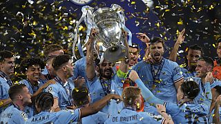 Manchester City's Ilkay Gundogan holds up the trophy after winning the Champions League final against Inter Milan at the Ataturk Olympic Stadium, Turkey.