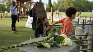 Roses lay at the playground after a knife attack Thursday, June 8, 2023 in Annecy, French Alps.