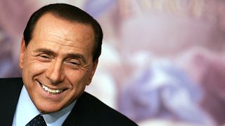Silvio Berlusconi smiling during a news conference in Rome in 2006, during his second term in office as Prime Minister.
