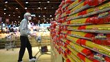 Customers look at packages of pasta on sale in a supermarket in Milan, northern Italy.