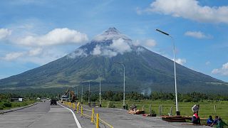 Mayon Volcano was gently spewing lava down its slopes on Monday, alerting tens of thousands of people they may have to quickly flee a violent and life-threatening eruption.