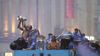 Manchester City's Ruben Dias and Erling Haaland celebrate during the parade to celebrate winning the Premier League, FA Cup and Champions League in Manchester, 12 June 2023