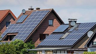 Rooftops on private houses are covered by solar panels to produce renewable electricity in Duelmen, Germany.