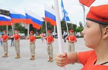 Wide shot members of a Russian patriotic youth movement holding national flags