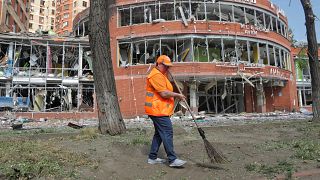 Municipal workers clean at the scene of a nightly Russian rocket attack in Odesa, Ukraine, Wednesday, June 14, 2023.