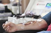 A person donates blood to the American Red Cross during a blood drive January 2022.